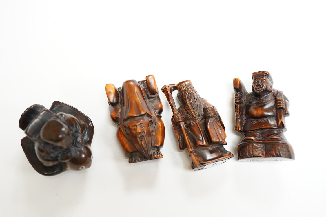 Four Japanese carved wood netsuke to include two elders and a novelty figure seated on a bird, largest 5cm high